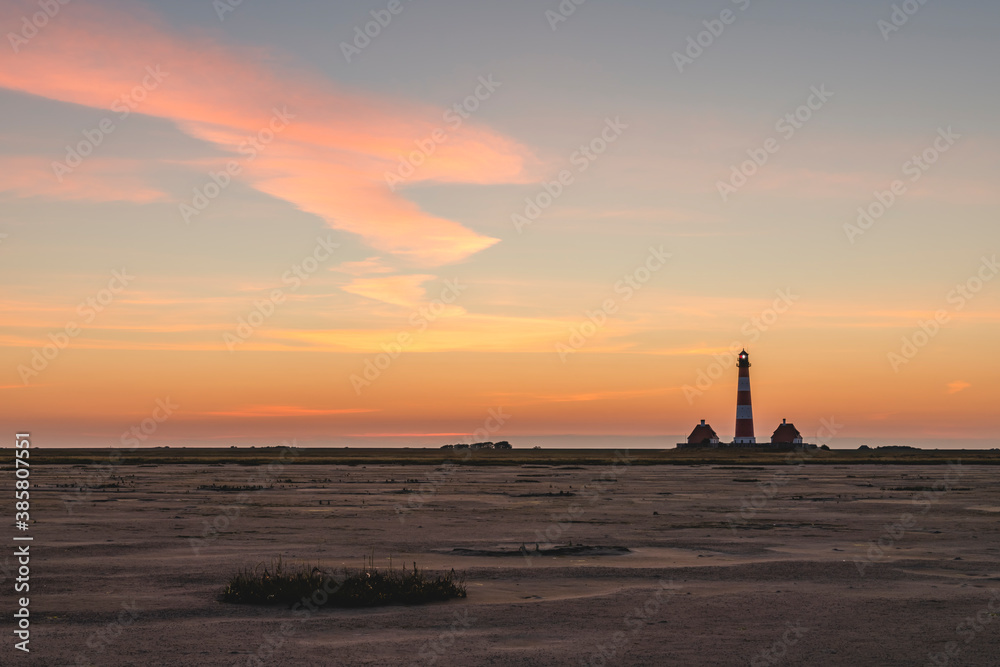 Germany, Schleswig-Holstein, Westerhever, Sandy beach at dawn with Westerheversand Lighthouse in background Germany, Schleswig-Holstein, Westerhever, Sandy beach at dawn with Westerheversand Lighthouse in background