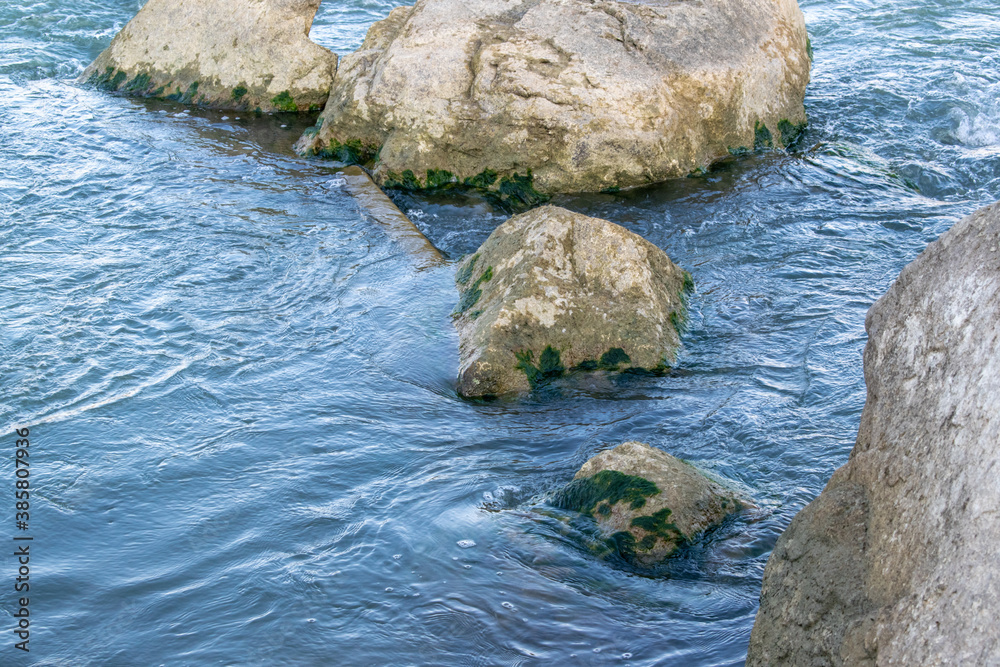 Rocks in the riverbed blue background summer Rocks in the riverbed blue background summer