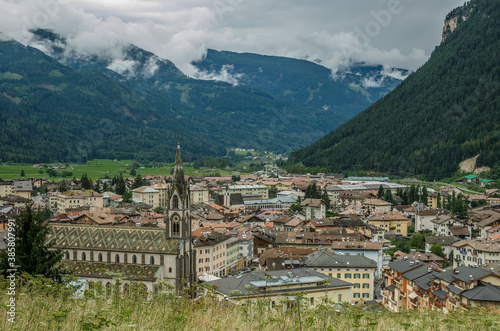 View of Predazzo village, located in Val di Fiemme, in a rainy day as seen from Bosca Fontana forest, Latemar mountain group, Dolomites, Trento province, Trentino, South Tirol, Italy.