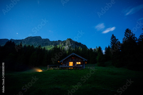 Secluded mountain hut at night photo