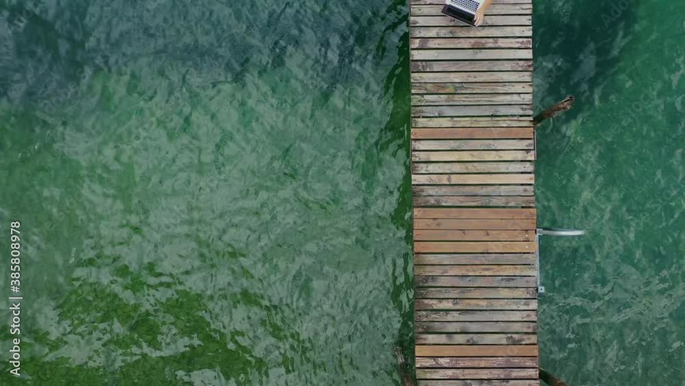 Men Working on His Laptop Online in Scenic Outdoor Remote Place. Wooden Pier.