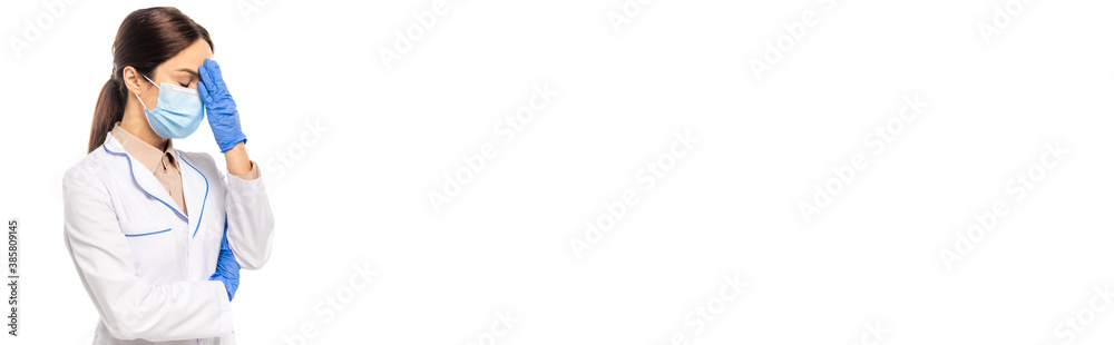 Panoramic shot of doctor in medical mask touching forehead isolated on white Panoramic shot of doctor in medical mask touching forehead isolated on white