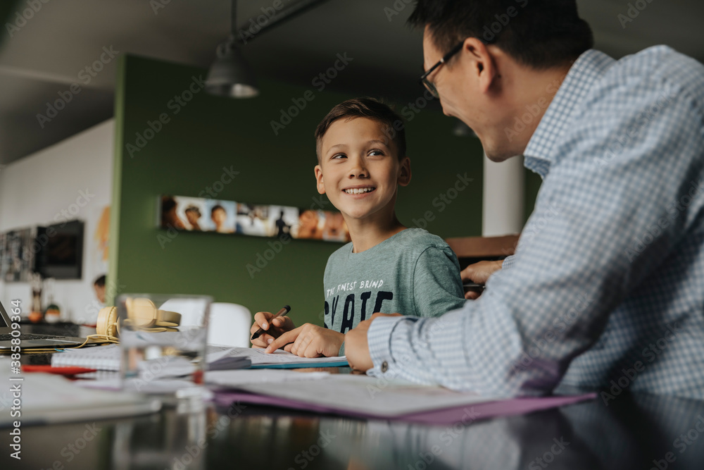 Father helping son with his homework Father helping son with his homework