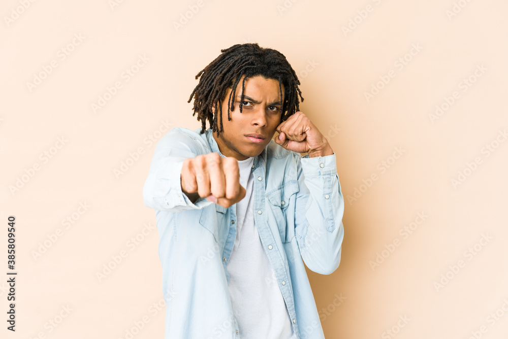 Young african american rasta man throwing a punch, anger, fighting due to an argument, boxing. Young african american rasta man throwing a punch, anger, fighting due to an argument, boxing.
