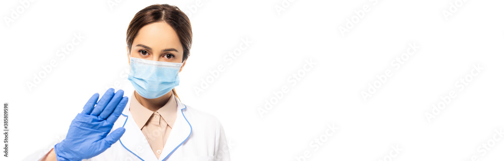Panoramic shot of doctor in medical mask showing stop gesture isolated on white Panoramic shot of doctor in medical mask showing stop gesture isolated on white