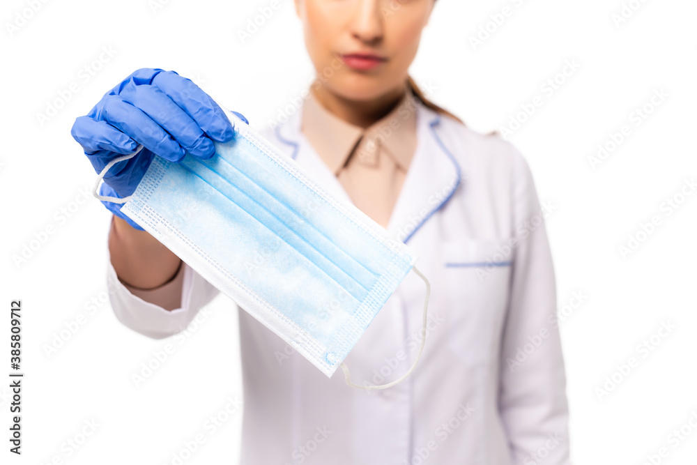 Cropped view of doctor in latex glove showing medical mask isolated on white Cropped view of doctor in latex glove showing medical mask isolated on white