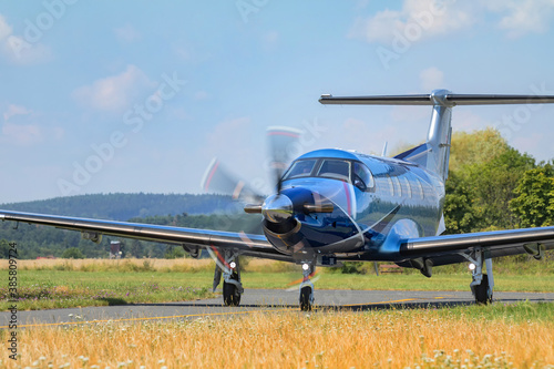 Single-engine turboprop blue airplane. Blue Airplane on runway. photo