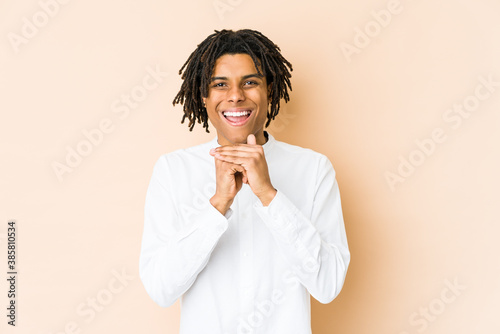 Bild auf Leinwand Young african american rasta man praying for luck, amazed and opening mouth looking to front