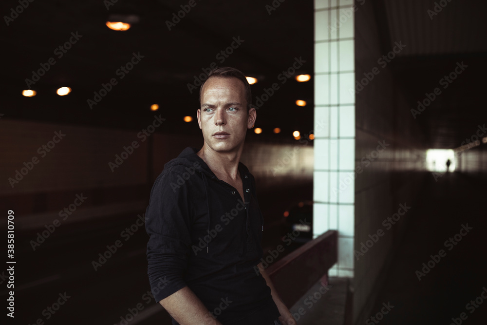 Contemplating man standing in tunnel Contemplating man standing in tunnel