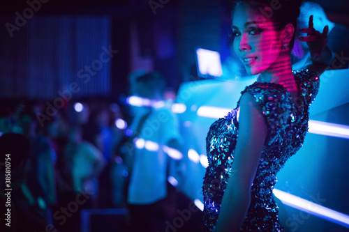Beautiful woman smiling and dancing in nightclub photo