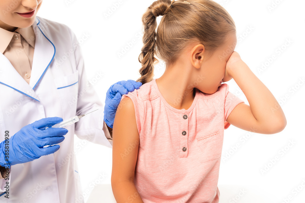 Pediatrician holding syringe near frightened child isolated on white Pediatrician holding syringe near frightened child isolated on white