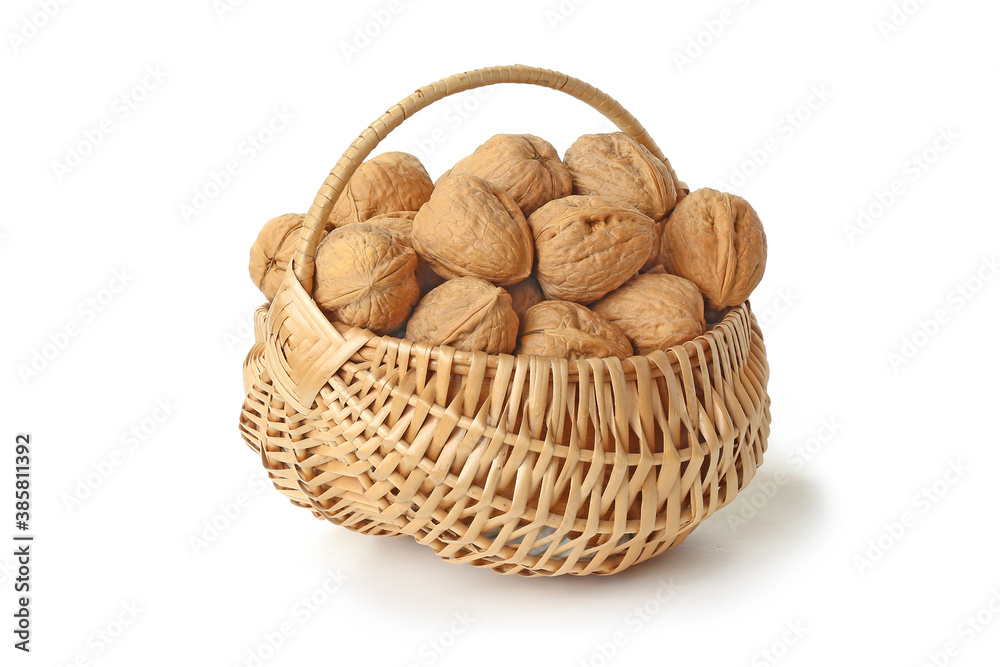 Walnuts in a wicker basket isolated on the white Walnuts in a wicker basket isolated on the white