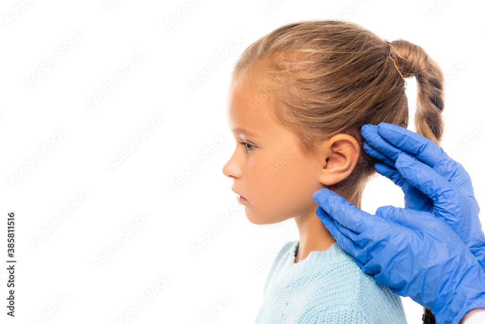 Pediatrician in latex gloves touching ear of girl isolated on white Pediatrician in latex gloves touching ear of girl isolated on white