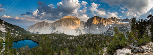 View of Black Lake with Buck Mountain and Temple Crag against cloudy sky photo