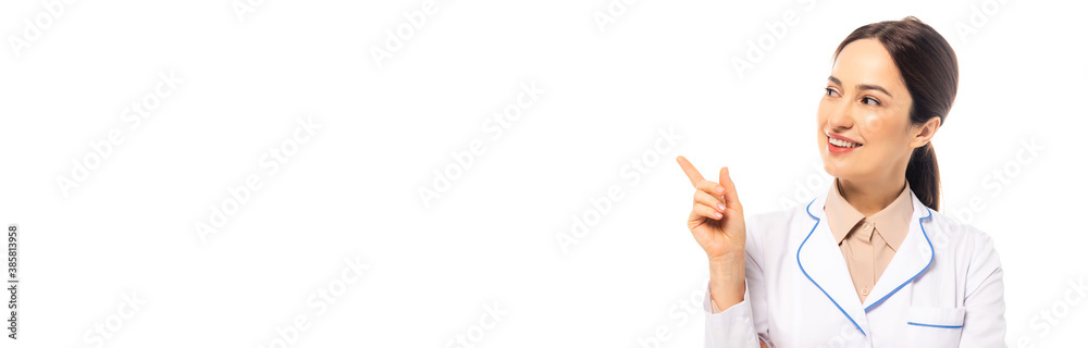 Horizontal crop of cheerful doctor pointing with finger isolated on white Horizontal crop of cheerful doctor pointing with finger isolated on white