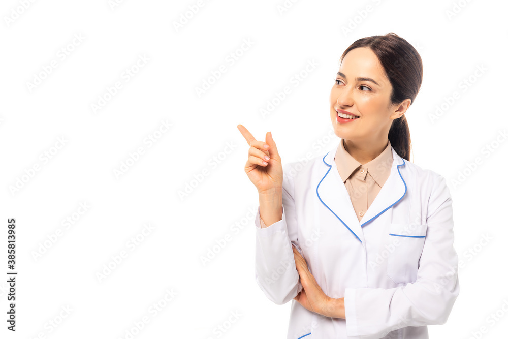 Smiling doctor in white coat pointing with finger isolated on white Smiling doctor in white coat pointing with finger isolated on white