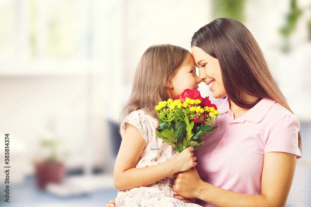 Happy Mother and daughter hugging with flowers Happy Mother and daughter hugging with flowers