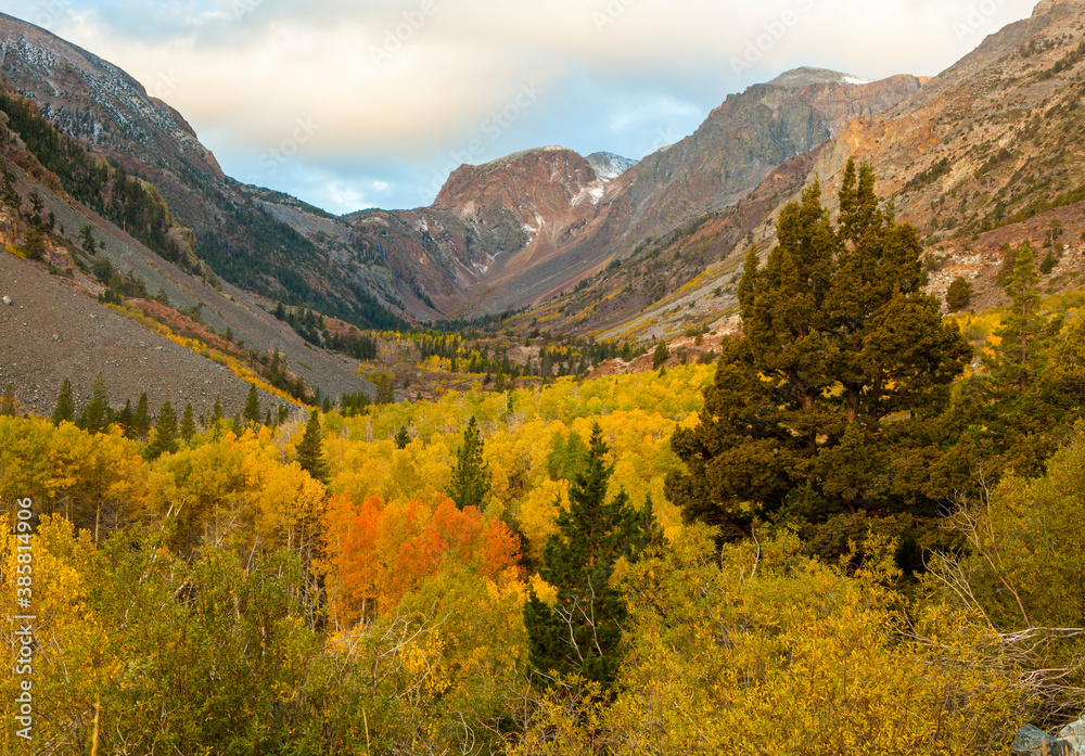 Scenic view of Lundy Canyon Trail with autumn trees in foreground during sunrise Scenic view of Lundy Canyon Trail with autumn trees in foreground during sunrise