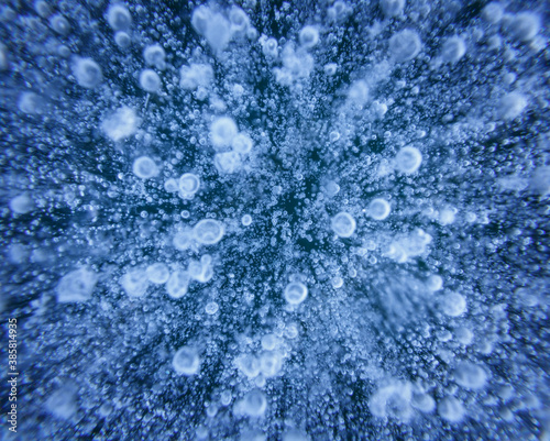 Close up of ice bubbles and patterns in frozen lake