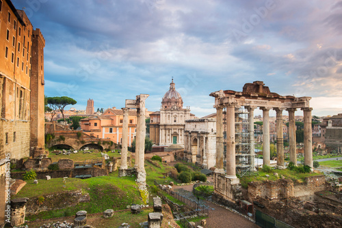 View of Colosseum and Roman Forum against cloudy sky photo