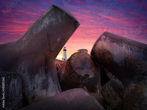 Walton Lighthouse seen through tetrapod blocks during sunrise photo