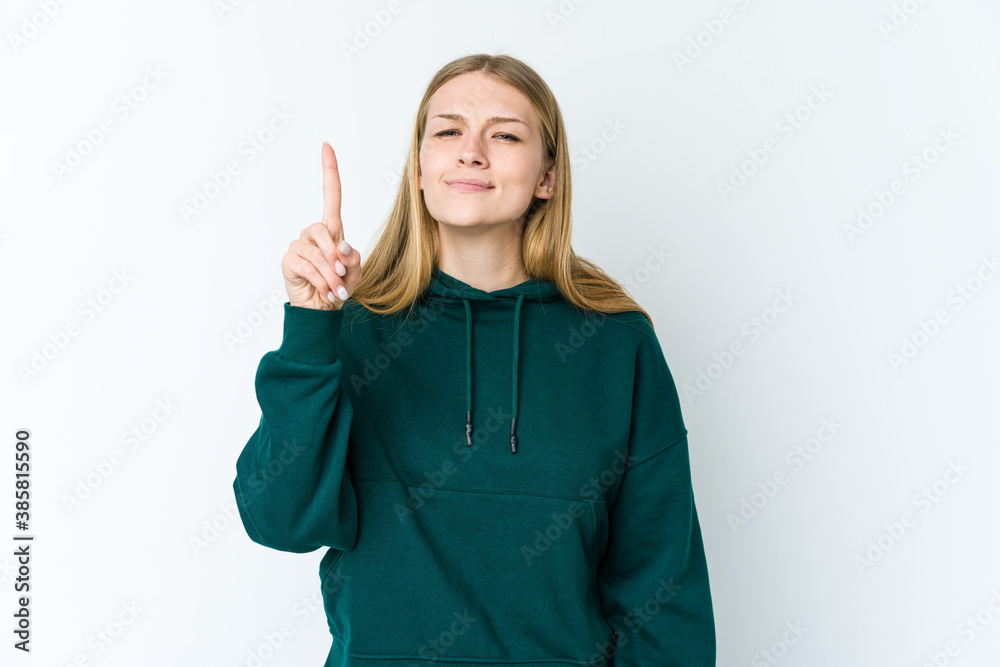 Young blonde woman isolated on white background showing number one with finger. Young blonde woman isolated on white background showing number one with finger.