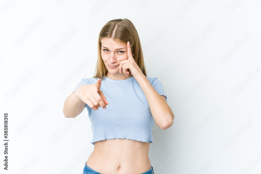 Young blonde woman isolated on white background pointing temple with finger, thinking, focused on a task. Young blonde woman isolated on white background pointing temple with finger, thinking, focused on a task.