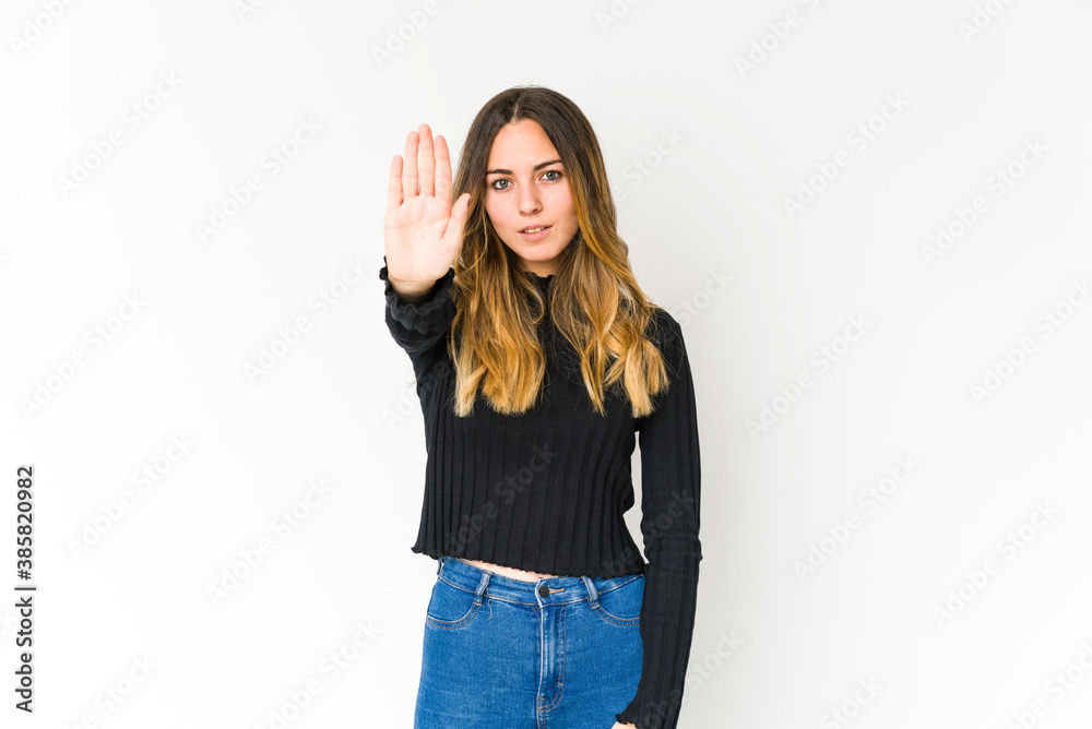 Young caucasian woman isolated on white background standing with outstretched hand showing stop sign, preventing you. Young caucasian woman isolated on white background standing with outstretched hand showing stop sign, preventing you.