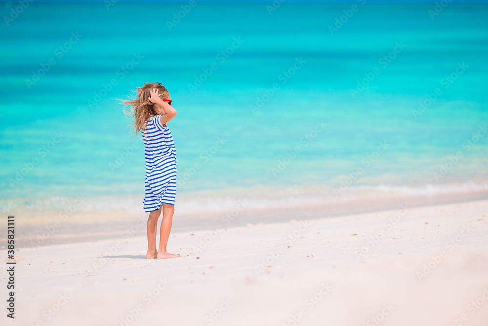 Adorable little girl at beach on her summer vacation Adorable little girl at beach on her summer vacation
