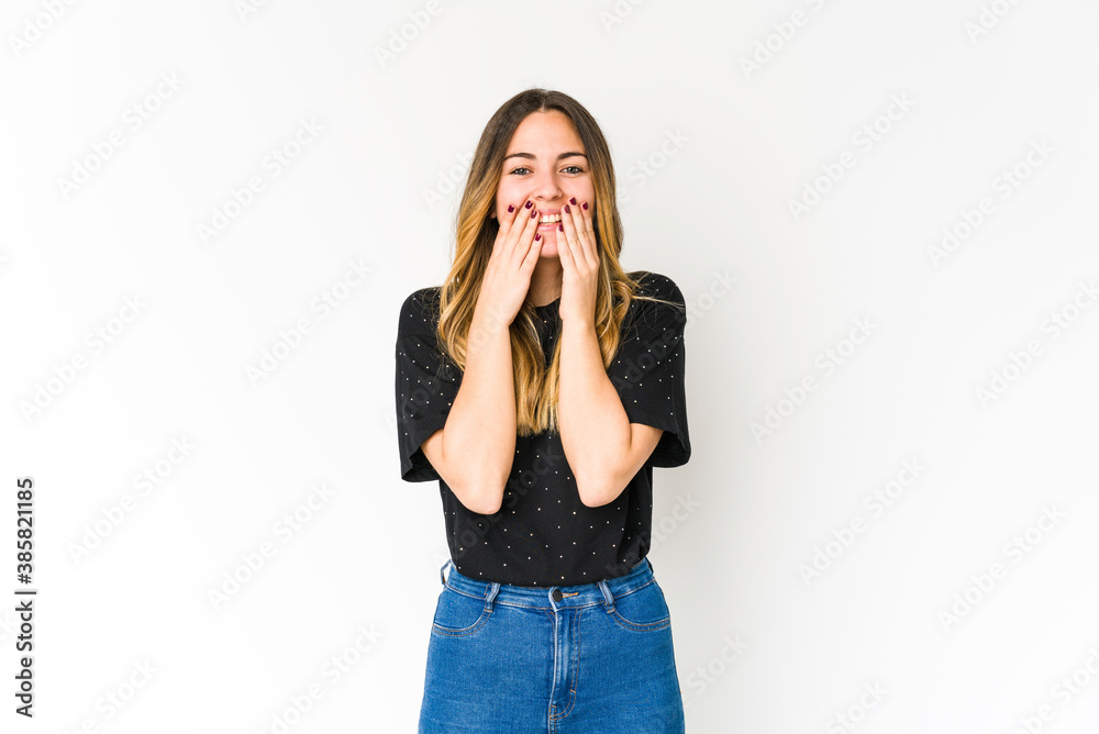 Young caucasian woman isolated on white background laughing about something, covering mouth with hands. Young caucasian woman isolated on white background laughing about something, covering mouth with hands.