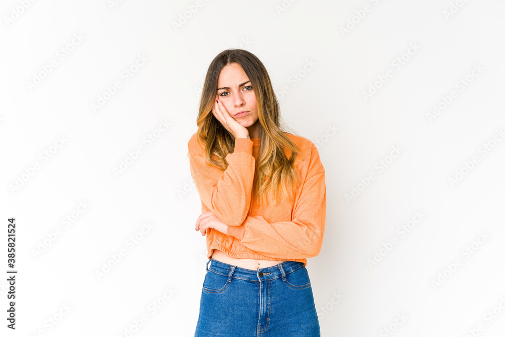 Young caucasian woman isolated on white background who feels sad and pensive, looking at copy space. Young caucasian woman isolated on white background who feels sad and pensive, looking at copy space.