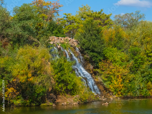 Fototapeta Naklejka Na Ścianę i Meble -  beautiful waterfall rushing from mount slope to an emerald lake
