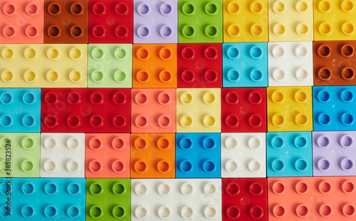 Flat background of plastic colorful bricks