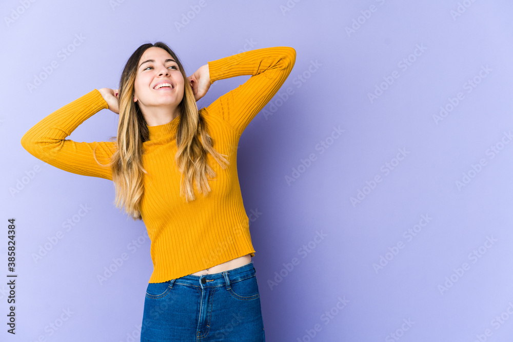Young caucasian woman isolated on purple background stretching arms, relaxed position.