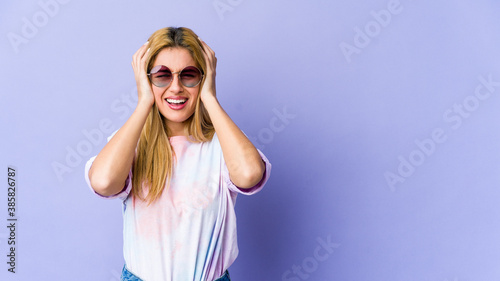 Young blonde caucasian woman crying, unhappy with something, agony and confusion concept.