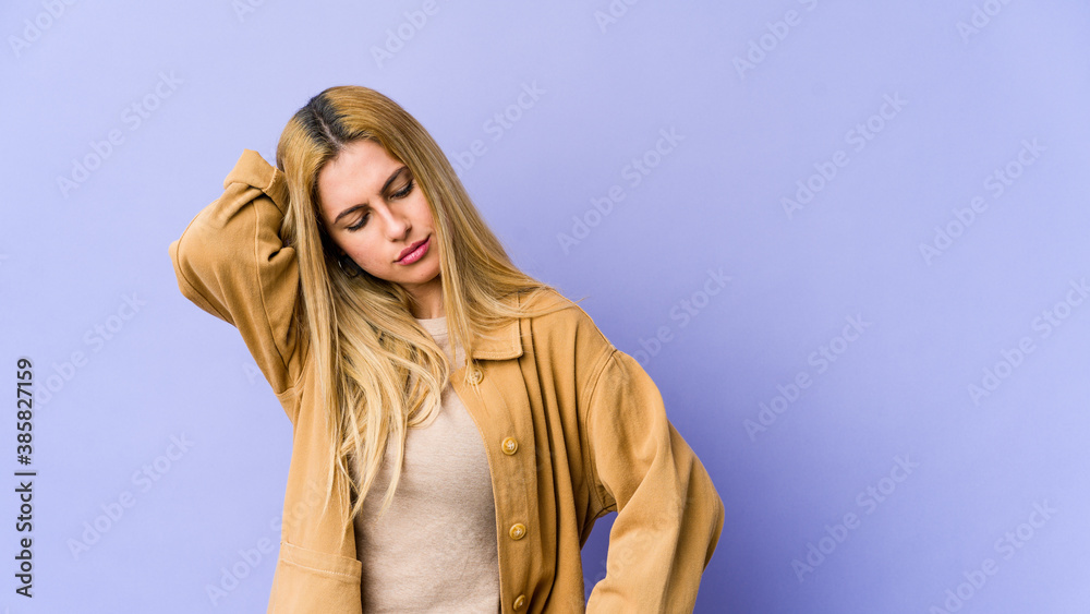 Young blonde caucasian woman tired and very sleepy keeping hand on head. Young blonde caucasian woman tired and very sleepy keeping hand on head.