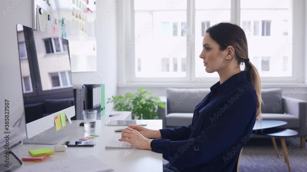 Businesswoman working on computer from home office Businesswoman working on computer from home office