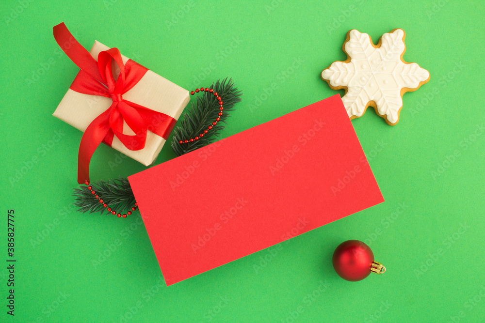 Top view of  blank red paper for Christmas greetings and gift  on the green background