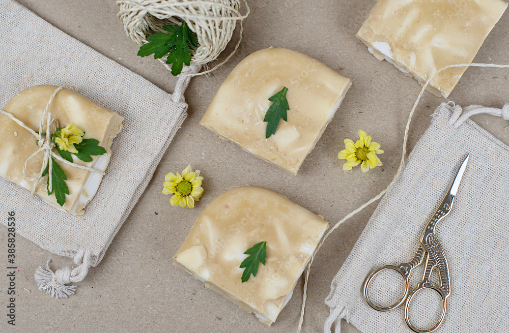 handmade soap made from squeezing soap slivers on wrapping paper, the concept of spa and self-care at home, packing a gift made with your own hands