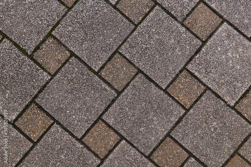 fragment of sidewalk from square tiles of different sizes