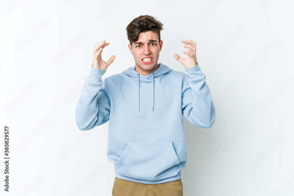 Young caucasian man isolated on white background screaming with rage. Young caucasian man isolated on white background screaming with rage.