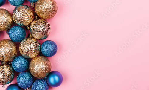 Christmas composition. Gold blue decorations on pastel pink background. Christmas, winter, new year concept. Flat lay, top view, copy space.