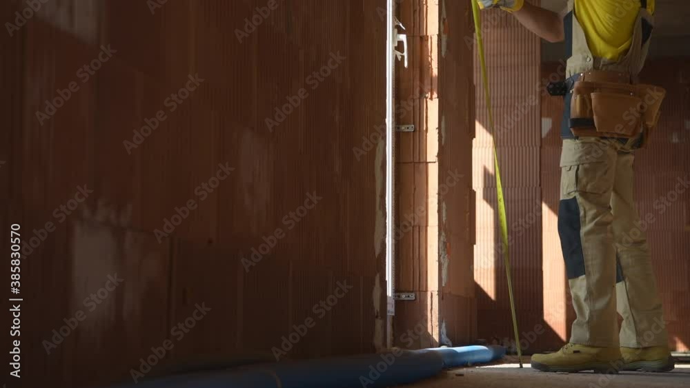 Construction Contractor Measuring Concrete Blocks Window Element. Industrial Theme. Construction Contractor Measuring Concrete Blocks Window Element. Industrial Theme.