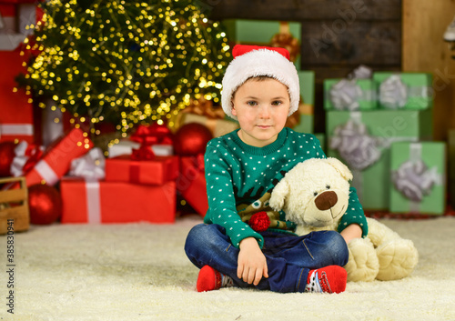 Winter holidays. Happy child celebrate new year. Christmas eve. Cute baby. Cherished dreams. Happy childhood. Little boy play near christmas tree. Kid fun home. Merry christmas everyone. Xmas present