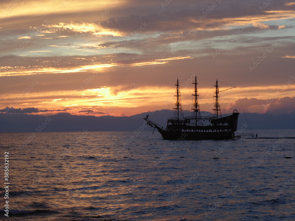 Sunset on a Turkish beach. Mediterranean Sea. View of the ship.