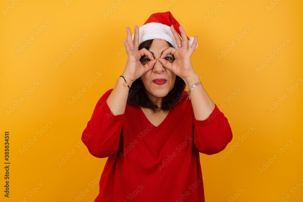 Playful excited teenage female with dark long hair showing Ok gestures with both hands, pretending to wear spectacles, astonished to see something amazing. Emotions, body language and gestures� Playful excited teenage female with dark long hair showing Ok gestures with both hands, pretending to wear spectacles, astonished to see something amazing. Emotions, body language and gestures�