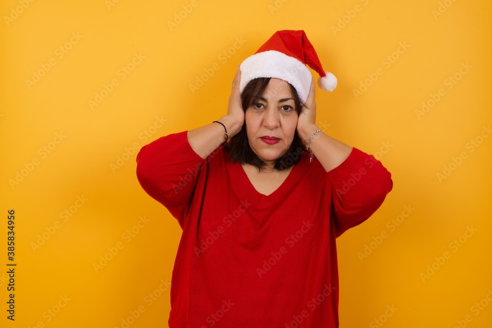 Woman plugging ears with hands does not wanting to listen hard rock or loud music. European Young female ignoring noise or din covering her ears with hands avoiding loud sounds at street. Woman plugging ears with hands does not wanting to listen hard rock or loud music. European Young female ignoring noise or din covering her ears with hands avoiding loud sounds at street.