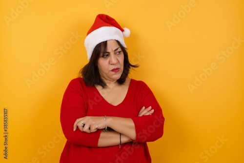 Closeup portrait displeased pissed off angry grumpy pessimistic woman with bad attitude, arms crossed looking sideways. Negative human emotion facial expression feelings