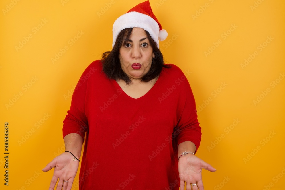Puzzled and clueless young woman with arms out, shrugging her shoulders, saying: who cares, so what, I don't know. Negative human emotions, facial expressions, life perception and attitude.