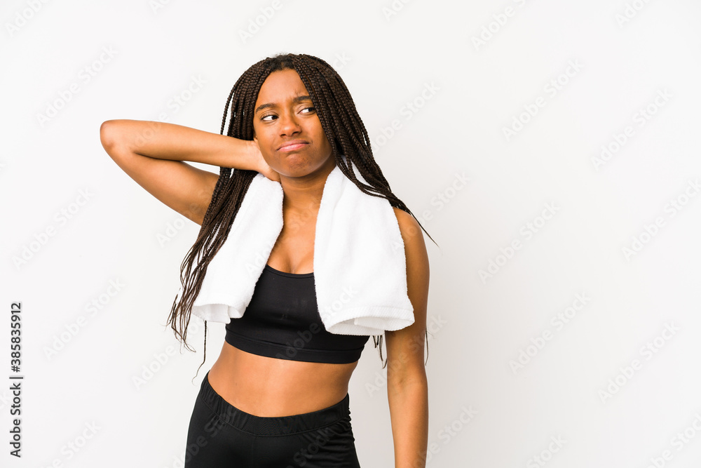 Young african american sport woman isolated touching back of head, thinking and making a choice.